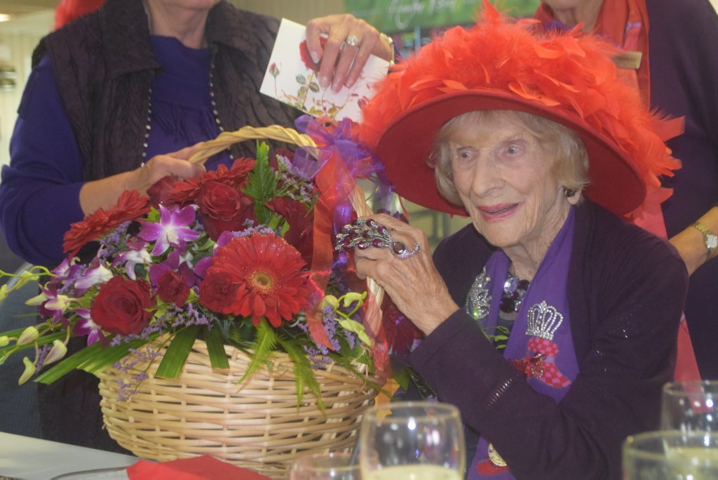 Florence Slattery with the big basket of flowers gifted to her for her 100th birthday from her beloved Rose City Red Hatters. Photo Jayden Brown / Warwick Daily News